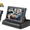 Black car rear-view mirror with an adjustable camera mount and a screen showing a baby in a car seat, on a white background with the Kiwi Shack logo.