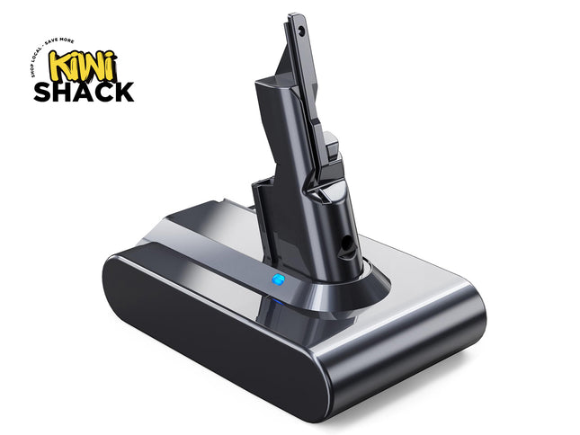 A black and dark gray wireless vacuum cleaner battery shown standing upright in its charging dock, with a blue LED indicator light. The Kiwi Shack logo is visible in the top-left corner.