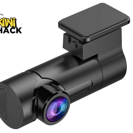 A black dash cam with a glossy finish and a purple-blue iridescent lens, shown on a white background with the Kiwi Shack logo in the top-left corner.