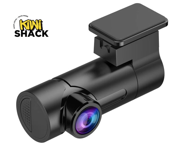 A black dash cam with a glossy finish and a purple-blue iridescent lens, shown on a white background with the Kiwi Shack logo in the top-left corner.