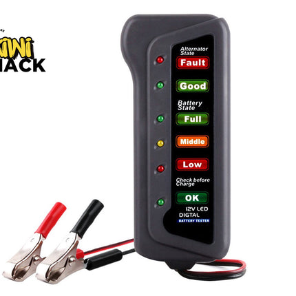 Grey handheld 12V LED digital battery and alternator tester with red and black alligator clip leads. Display panel shows Alternator State (Fault red LED, Good green LED) and Battery State (Full green, Middle yellow, Low red, Check before Charge OK green), labeled "12V LED DIGTAL BATTERY TESTER". Kiwi Shack logo in top-left corner.