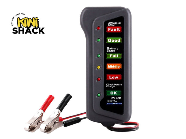 Grey handheld 12V LED digital battery and alternator tester with red and black alligator clip leads. Display panel shows Alternator State (Fault red LED, Good green LED) and Battery State (Full green, Middle yellow, Low red, Check before Charge OK green), labeled "12V LED DIGTAL BATTERY TESTER". Kiwi Shack logo in top-left corner.