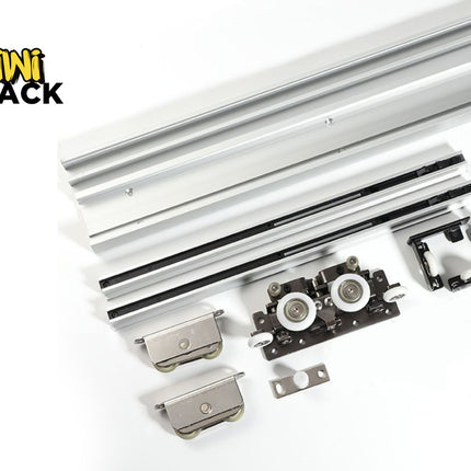 Heavy-duty sliding door track hardware set including extruded aluminum upper and lower tracks, tandem roller carriages, floor guides, and mounting brackets, with Kiwi Shack logo in top left.