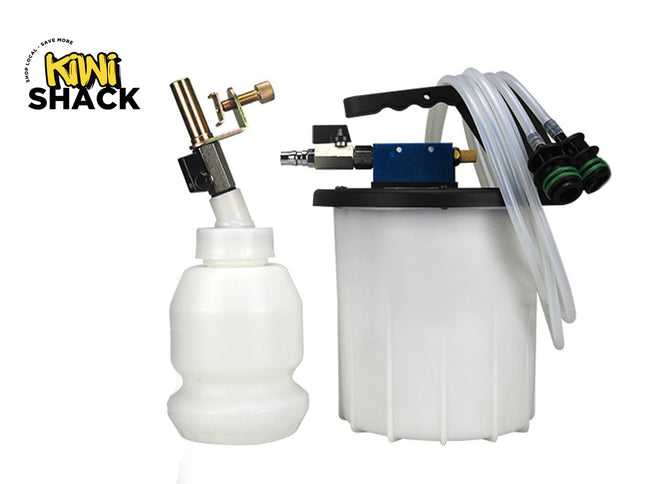 Kini Shack mini foam cannon and foam tank kit on a white background, featuring a white plastic bottle with a brass and black spray nozzle on the left, and a white plastic tank with a black top, blue pump housing, and clear hoses on the right.