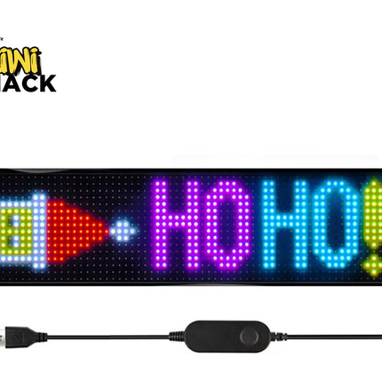 A 16x2 LED sign displaying 'HO HO!' in colorful lights, shown with its USB cable and controller on a white background with the Kiwi Shack logo.