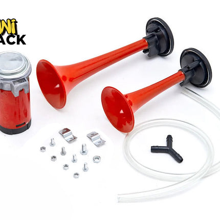 A dual-trumpet air horn kit with a red electric air compressor, two red plastic trumpet horns of different lengths, clear vinyl tubing, a Y-connector, and mounting hardware against a white background, featuring the "Kiwi Shack" logo in the upper left corner.