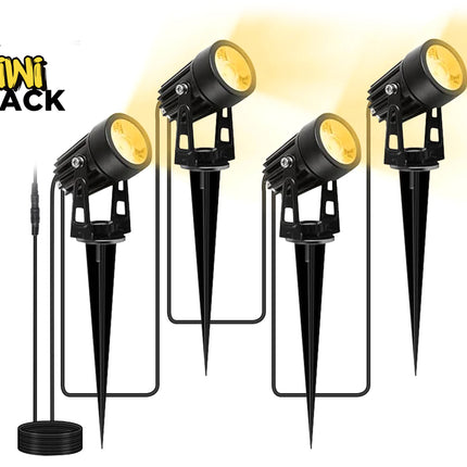 Four black outdoor landscape lights with stake mounts and a separate black power cord, shown on a white background with a yellow glow effect. The Kiwi Shack logo is visible in the top left.