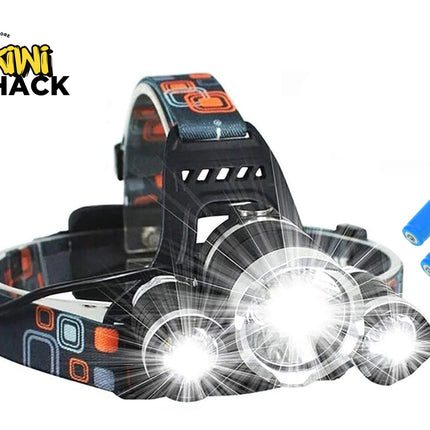 Black LED headlamp with a patterned strap, three illuminated headlight beams turned on, two blue batteries on the side, and the Kiwi Shack logo in the top left.