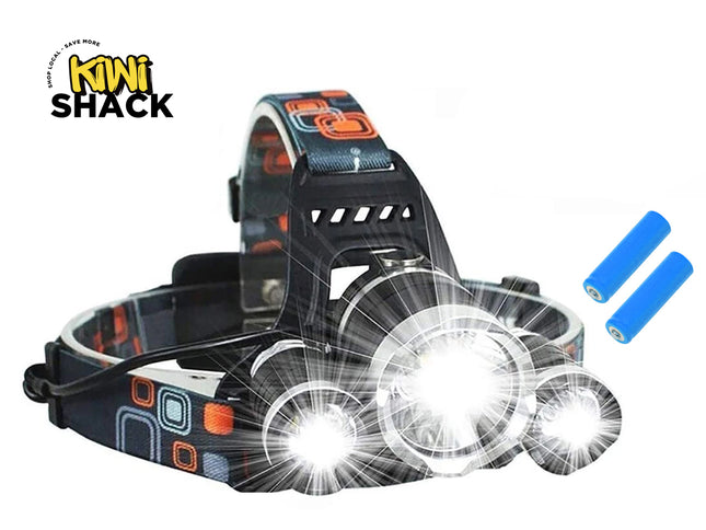 Black LED headlamp with a patterned strap, three illuminated headlight beams turned on, two blue batteries on the side, and the Kiwi Shack logo in the top left.