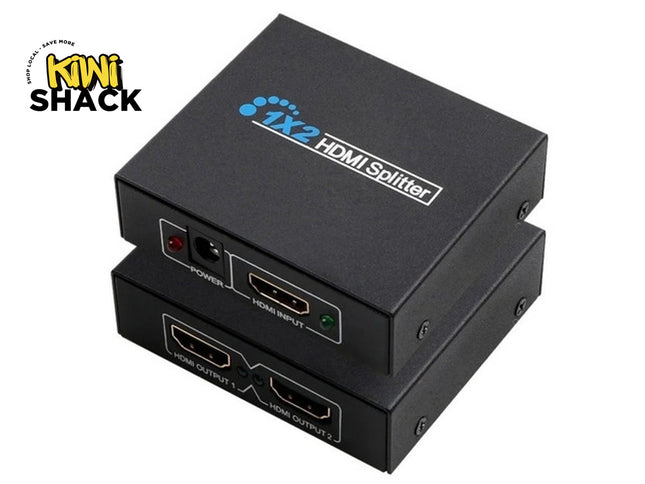 Two stacked black 1X2 HDMI Splitter metal boxes [cite: 2]. Top unit shows top-surface branding "1X2 HDMI Splitter" and front-facing DC power port with red LED, HDMI input port with green LED. Bottom unit shows front-facing HDMI Output 1 and HDMI Output 2 ports [cite: 2]. Kiwi Shack logo in top-left corner [cite: 2].