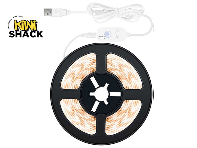A coiled warm white LED strip light on a black spool with a white USB cable and controller, shown on a white background with the Kiwi Shack logo in the top-left corner.