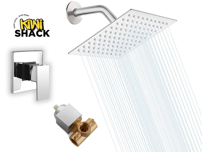 A modern square rain shower head with a wall-mounted arm and rectangular handle, shown with water flowing from the nozzle. A separate brass and white valve component is shown below, and a wall-mounted single-handle trim is shown to the left.
