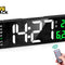 Large black rectangular digital LED wall/desk clock displaying white numbers showing time 14:21, green day-of-week indicator with "Fri" highlighted, green temperature display showing 29°C, green month/date display showing 6.23, accompanied by a hand holding a small infrared remote control with green signal waves, and the Kiwi Shack logo watermark.