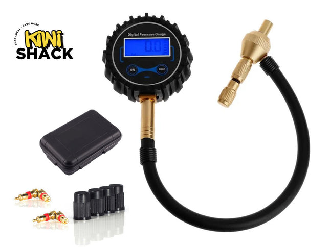 A digital tire pressure gauge with a rubber-armored LCD display, flexible hose, brass chuck, four black valve caps, replacement valve cores, and a small storage case against a white background. A "Kiwi Shack" logo appears in the top-left corner.