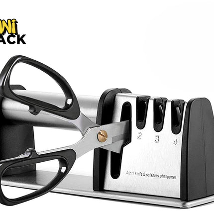 A 4-in-1 black and stainless steel knife and scissor sharpener being used to sharpen a pair of kitchen scissors with black handles against a white background. A "Kiwi Shack" logo appears in the top-left corner.