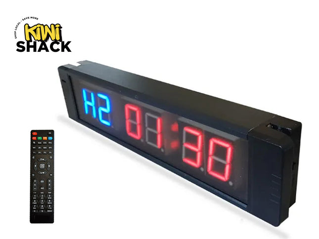 Digital clock with remote control on a white background, featuring the Kiwi Shack brand.