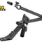 Black modular metal adjustment/mounting arm assembly featuring an articulated dual-bar linkage with hex-head fasteners, a clamp ring with a thumbscrew at the top end (with a small cylindrical insert hovering above), an angled slotted base bracket with a knurled cylindrical vertical adjustment knob and spring-loaded vertical slide plate, angular alignment scale marks, and the Kiwi Shack logo watermark.