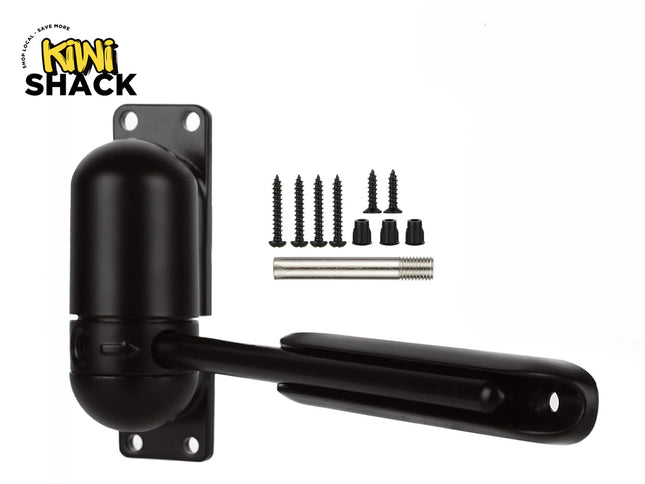 An adjustable black automatic door closer mechanism with mounting hardware screws and a pin, featuring the "Kiwi Shack" logo in the top-left corner.