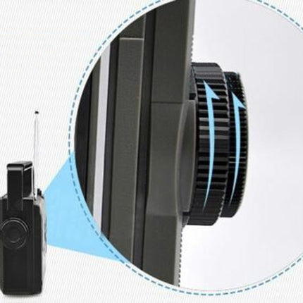 Close-up of a camera lens and attached small device on a light gray background