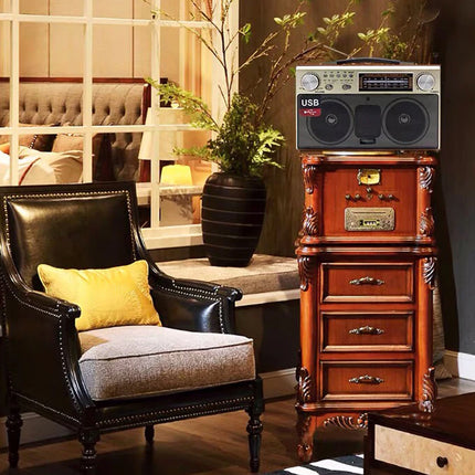 Vintage-style stereo system on a wooden cabinet next to a black leather armchair with a yellow pillow.