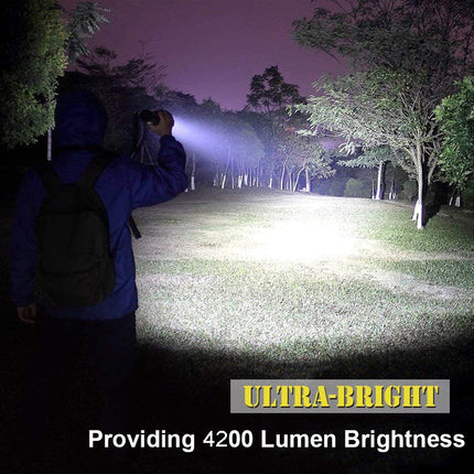 Person using a flashlight in a dark forest with 'Ultra-Bright' text indicating 4200 lumen brightness.