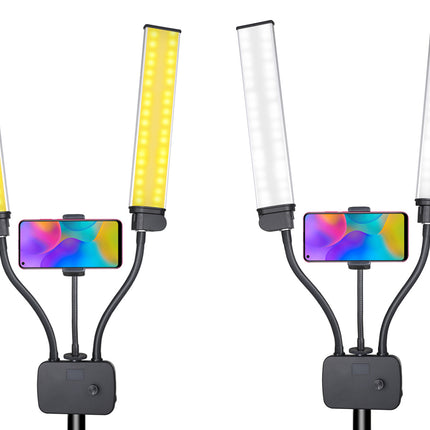 Two views of a dual LED light panel with a smartphone holder in the center, shown on a plain white background. The left view shows the lights turned yellow, and the right view shows them turned white.
