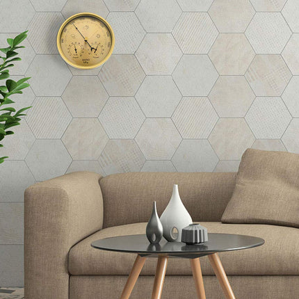 Living room with beige sofa, hexagonal tiled wall, and decorative items.
