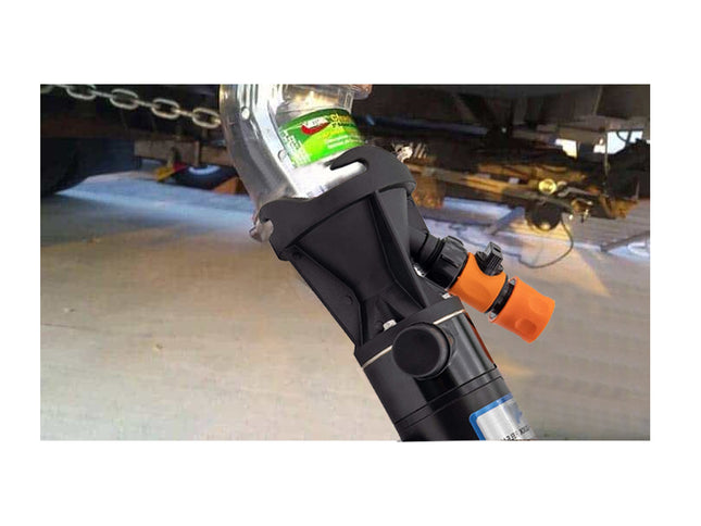 Close-up of a car jack with a green label on a vehicle, likely in a garage setting.