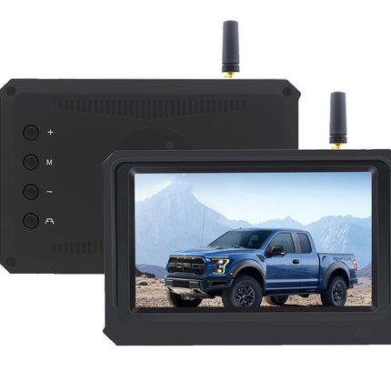 Monitor displaying a blue truck in a desert landscape with a black control panel on a white background