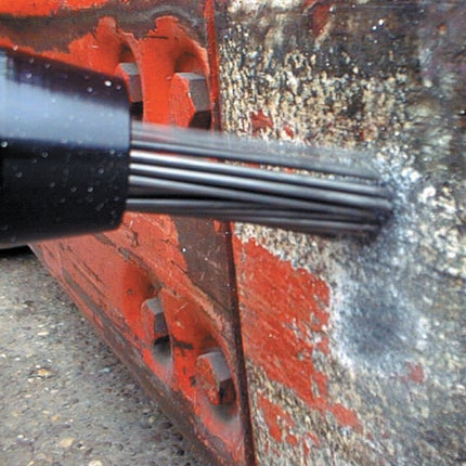 Close-up of a black metal rod against a red and gray background