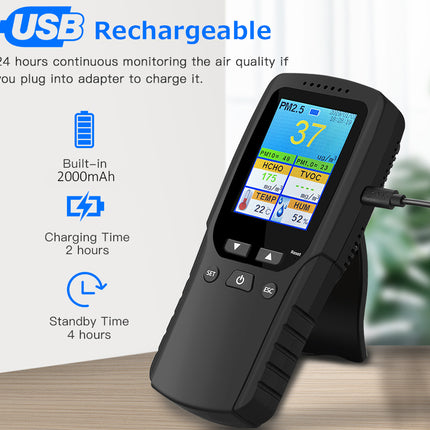Air quality monitor with digital display on a wooden surface, featuring text about USB rechargeability and specifications.
