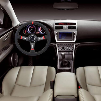 A car interior with beige leather front seats, a black steering wheel with red accents, a dark dashboard, and a center console with an infotainment screen.