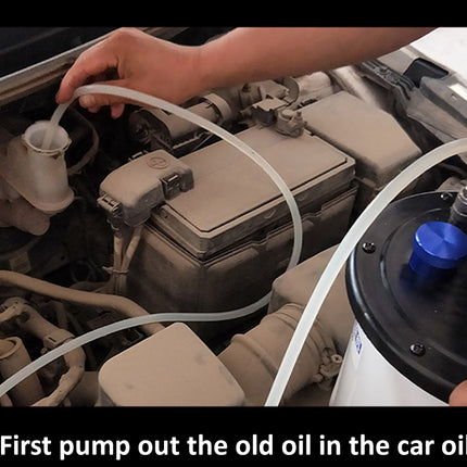 A close-up instructional photo of a person using a handheld oil-pump removal tool on a car oil filler cap inside an open engine bay. A text overlay at the bottom reads: 'STEP1.