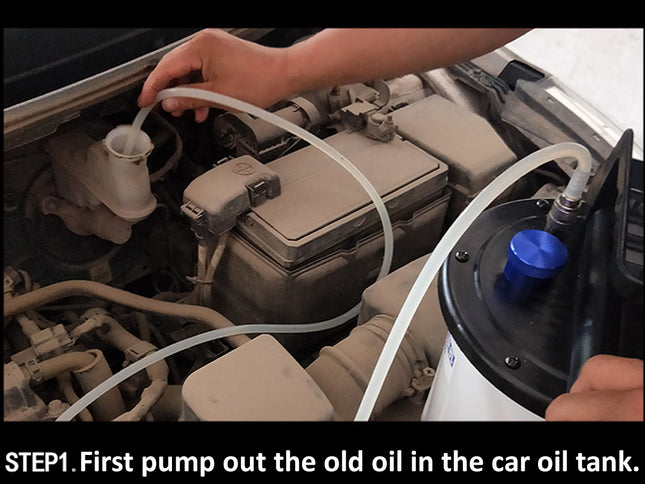 A close-up instructional photo of a person using a handheld oil-pump removal tool on a car oil filler cap inside an open engine bay. A text overlay at the bottom reads: 'STEP1.