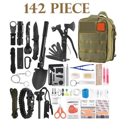 A 142-piece survival and emergency preparedness kit laid out on a white background next to an olive green tactical backpack. The kit includes various black and multi-tool items such as a folding shovel, knife, axe, flashlight, gloves, and rope, along with first aid supplies, patches, and other survival gear.