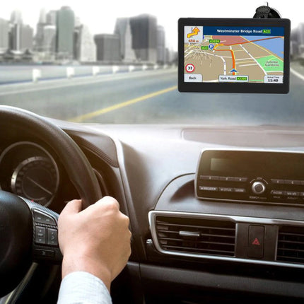 Car dashboard with a GPS device displaying a map, cityscape in the background