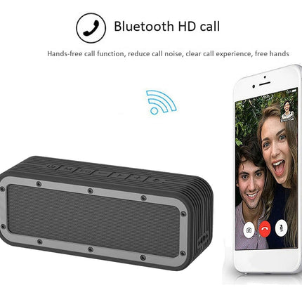 Black Bluetooth speaker with smartphone displaying a video call on a white background