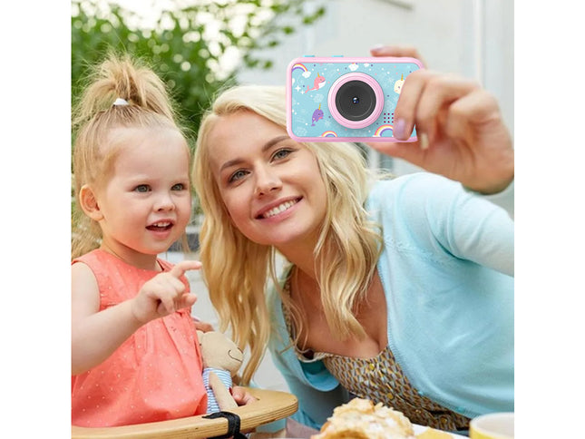 A woman and a young child taking a selfie with a small pink and blue camera featuring a cartoon cloud pattern.