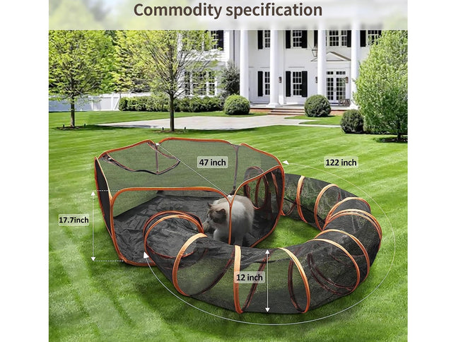 A dog playpen set up on a green lawn in front of a white house, with measurement labels showing dimensions of the enclosure. The product appears to be a black mesh playpen with orange trim and a tunnel section, and a small gray dog is visible inside.