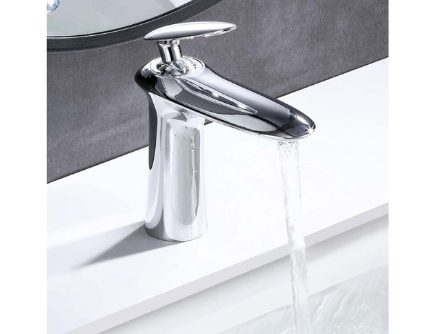 A polished chrome single-handle bathroom faucet with water flowing from the spout, mounted on a white sink against a dark gray wall.