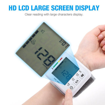 Digital blood pressure monitor with large screen display held by a hand on a white background