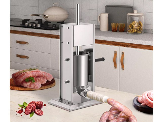 Stainless steel sausage stuffer in a kitchen setting with raw sausages and ingredients.