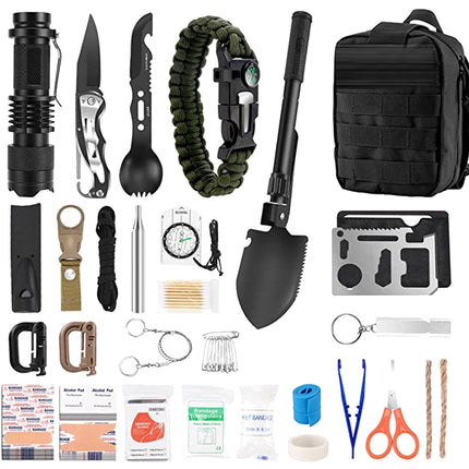 A comprehensive emergency survival kit laid out on a white background, featuring a black tactical flashlight, folding knife, paracord bracelet, black tactical backpack, black shovel, multi-tool card, shears, tape, fire starter, and first aid supplies.