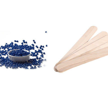 Blue pellets in a bowl next to wooden sticks on a white background