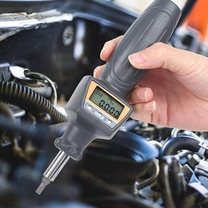 Digital dipstick being used to check oil level in a car engine