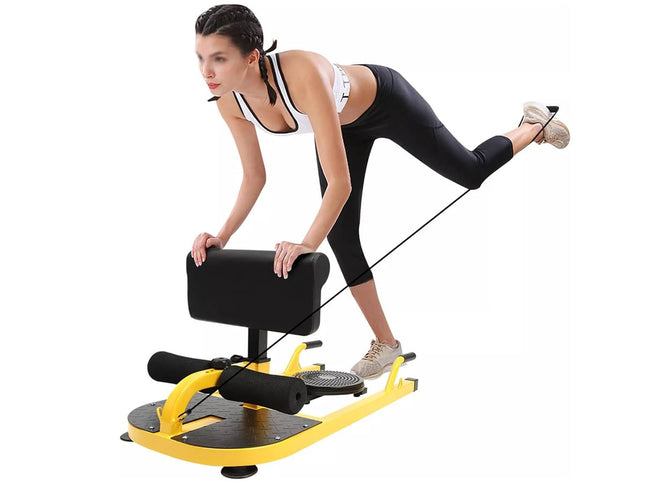 Woman exercising on a yellow and black exercise device against a white background