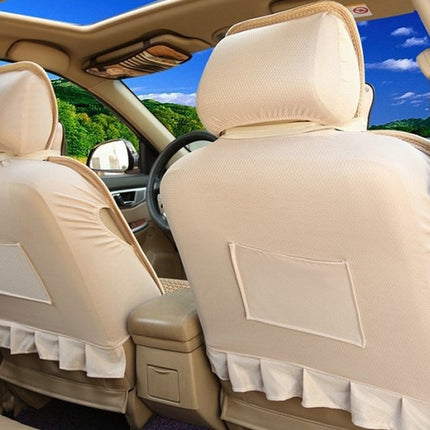 Beige car seat covers with ruffled trim and back pocket inserts installed on the front seats of a vehicle interior.