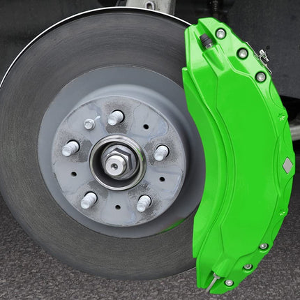 Close-up of a car wheel with a green brake caliper on a dark background