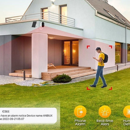 Person using a smartphone app in front of a modern house with security system features displayed.