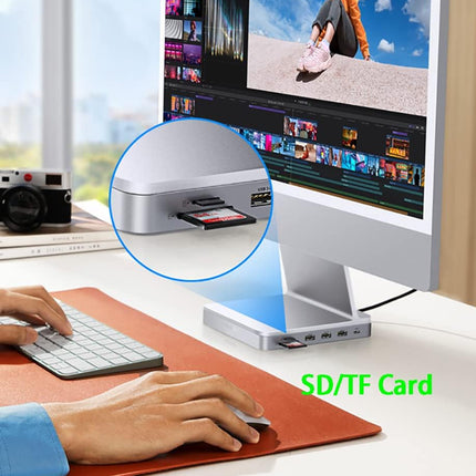 Person using a computer with an SD/TF card reader on a desk.
